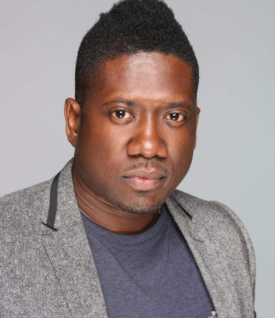 Photo of Andrew Copeland in front of a gray wall.